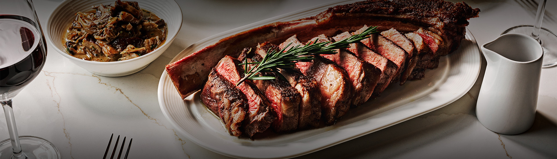a plate of meat with rosemary on it