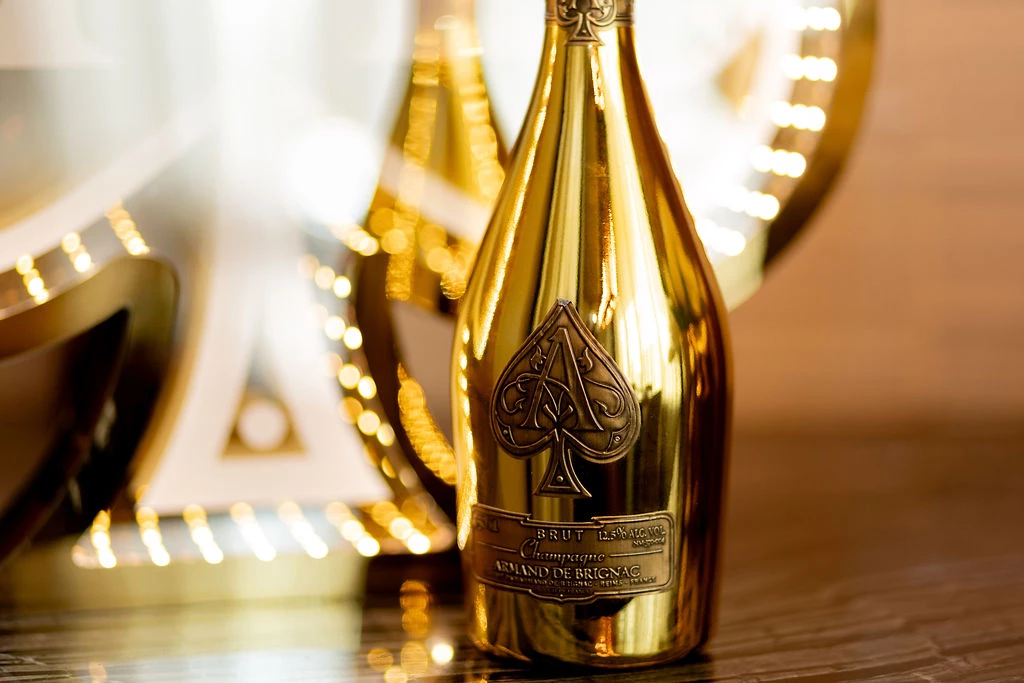 a gold bottle with a logo on it