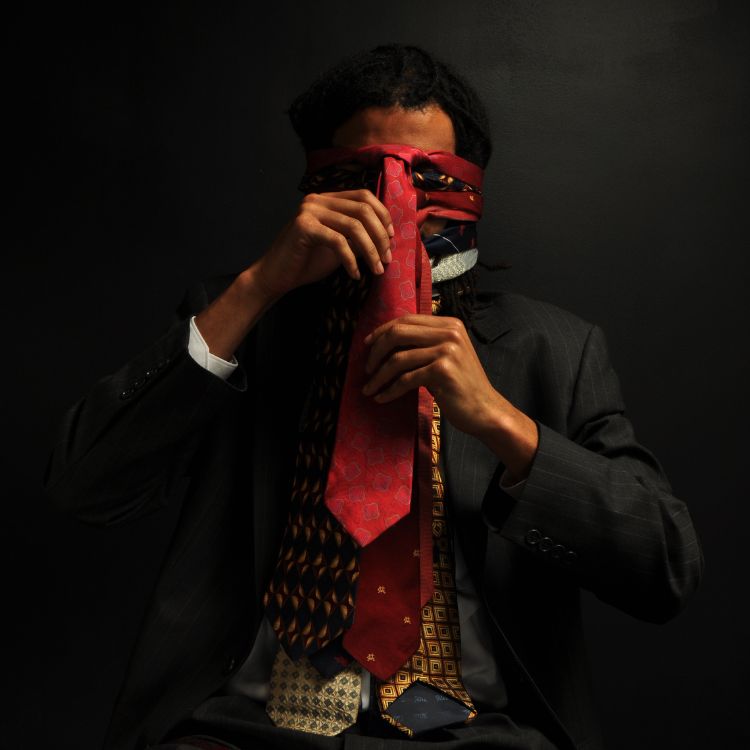 a man wearing a mask and tie
