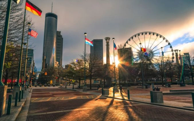 a city with tall buildings and a ferris wheel