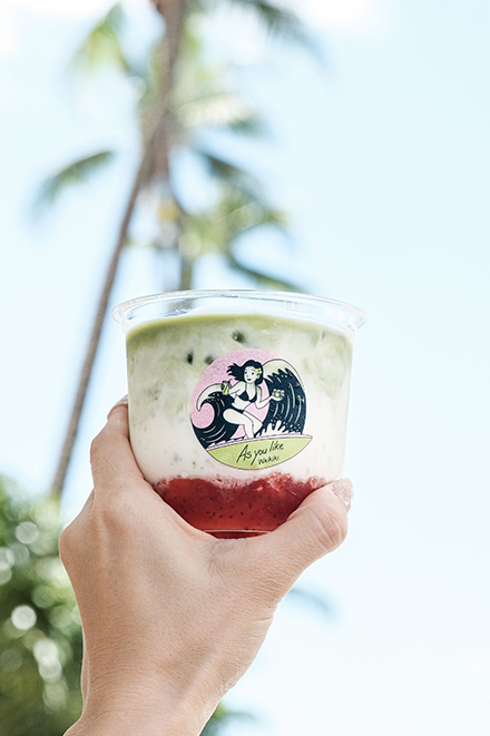 a hand holding a cup of food