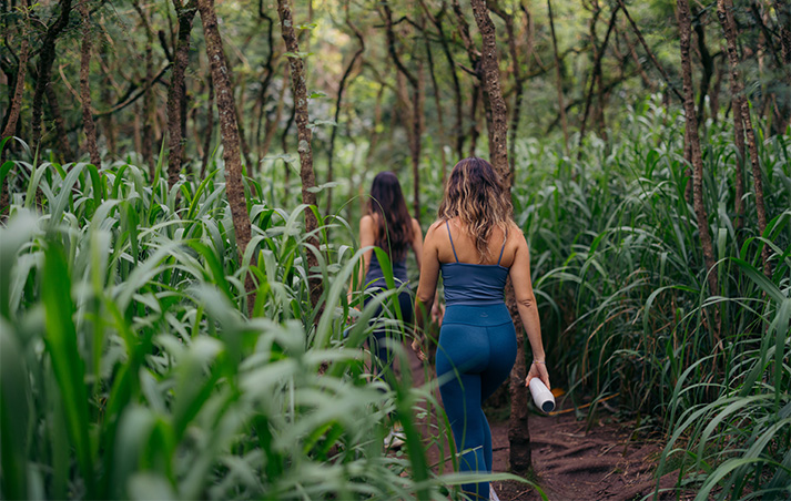 two women walking through the woods