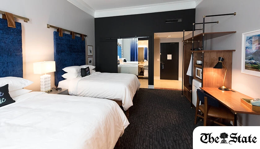 a room with two beds and a mirror