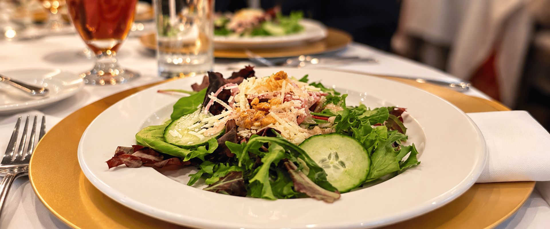 a plate of salad with cucumber and cheese