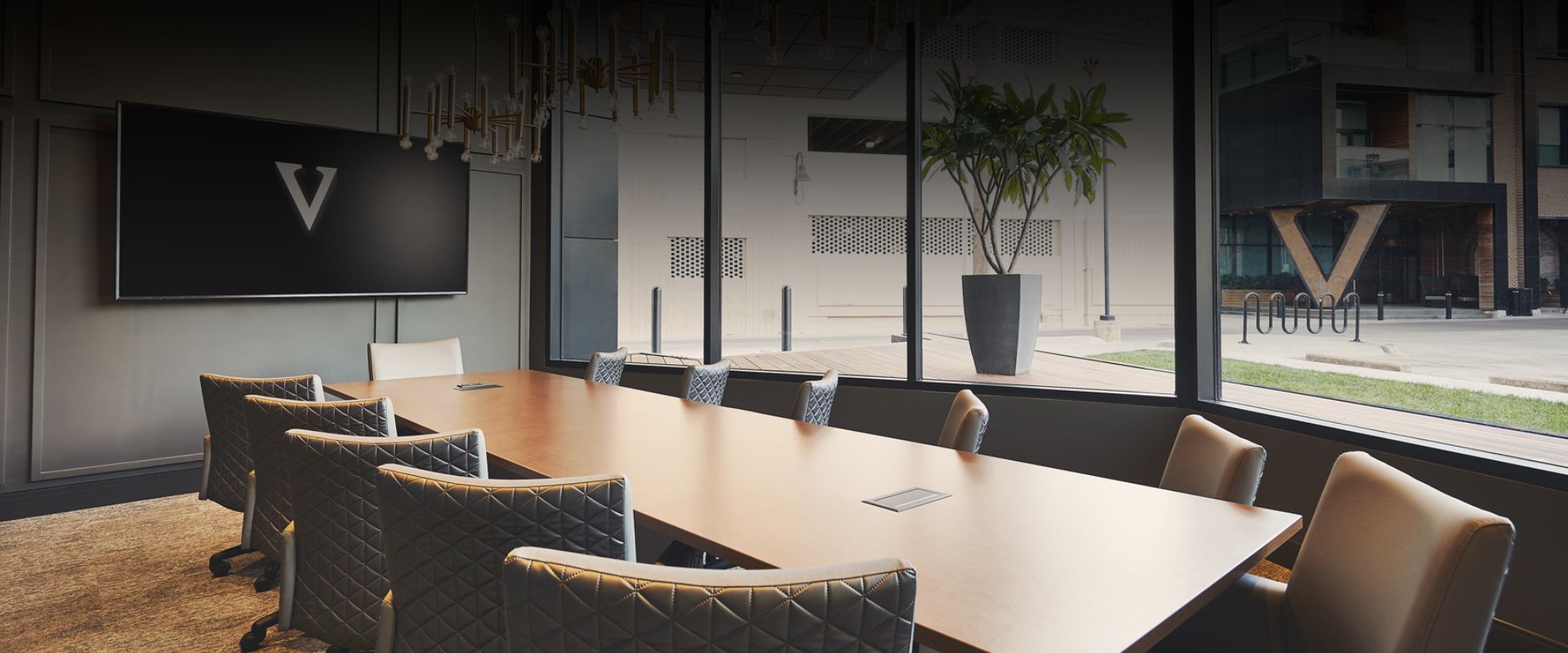 a long table with chairs in a room with windows