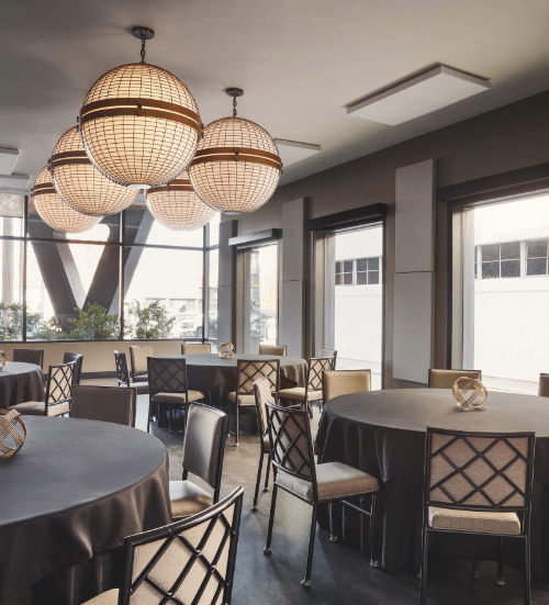 a room with round tables and chairs