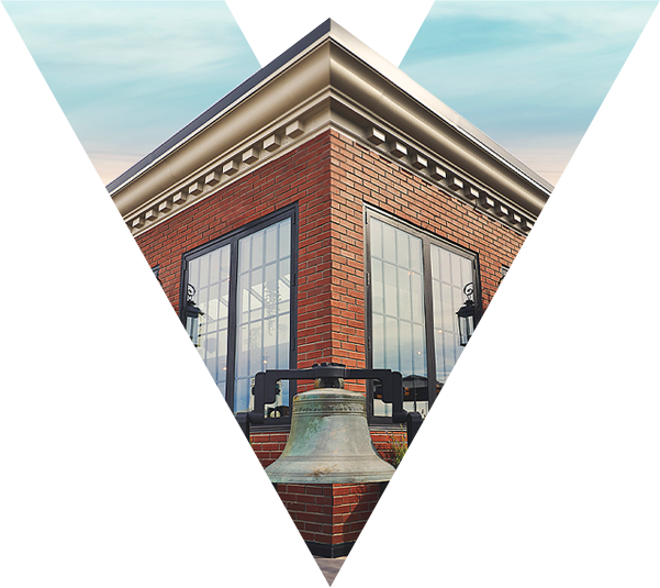 a brick building with a bell