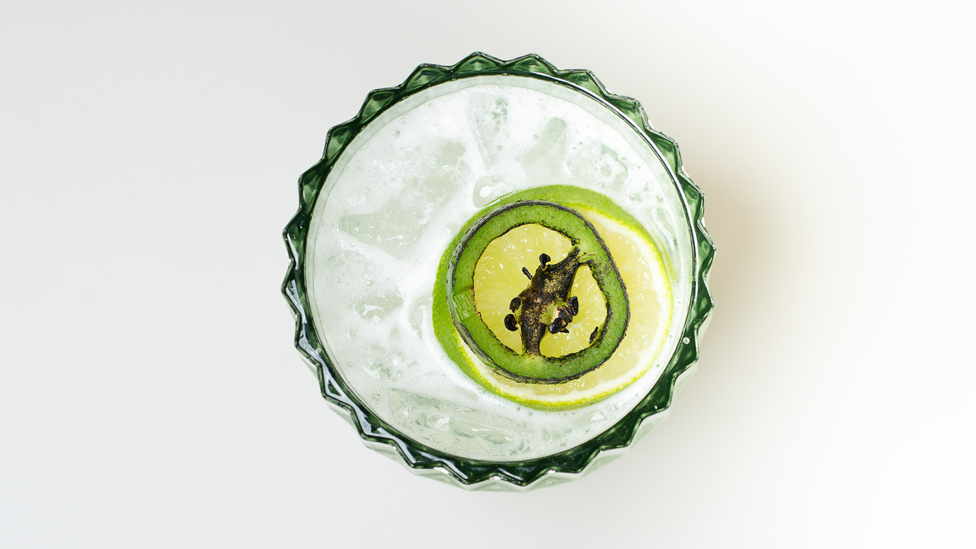 a glass with ice and a slice of lemon