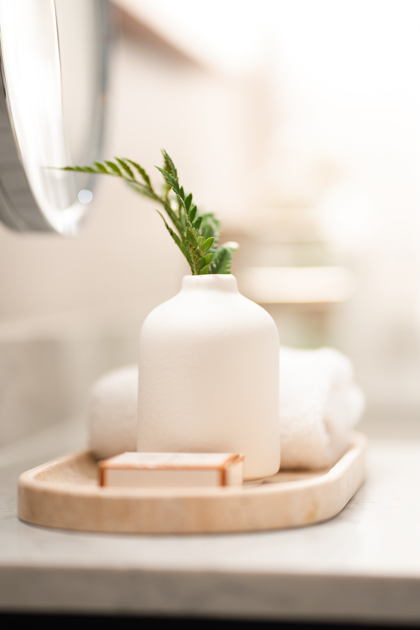 a white vase with a plant in it