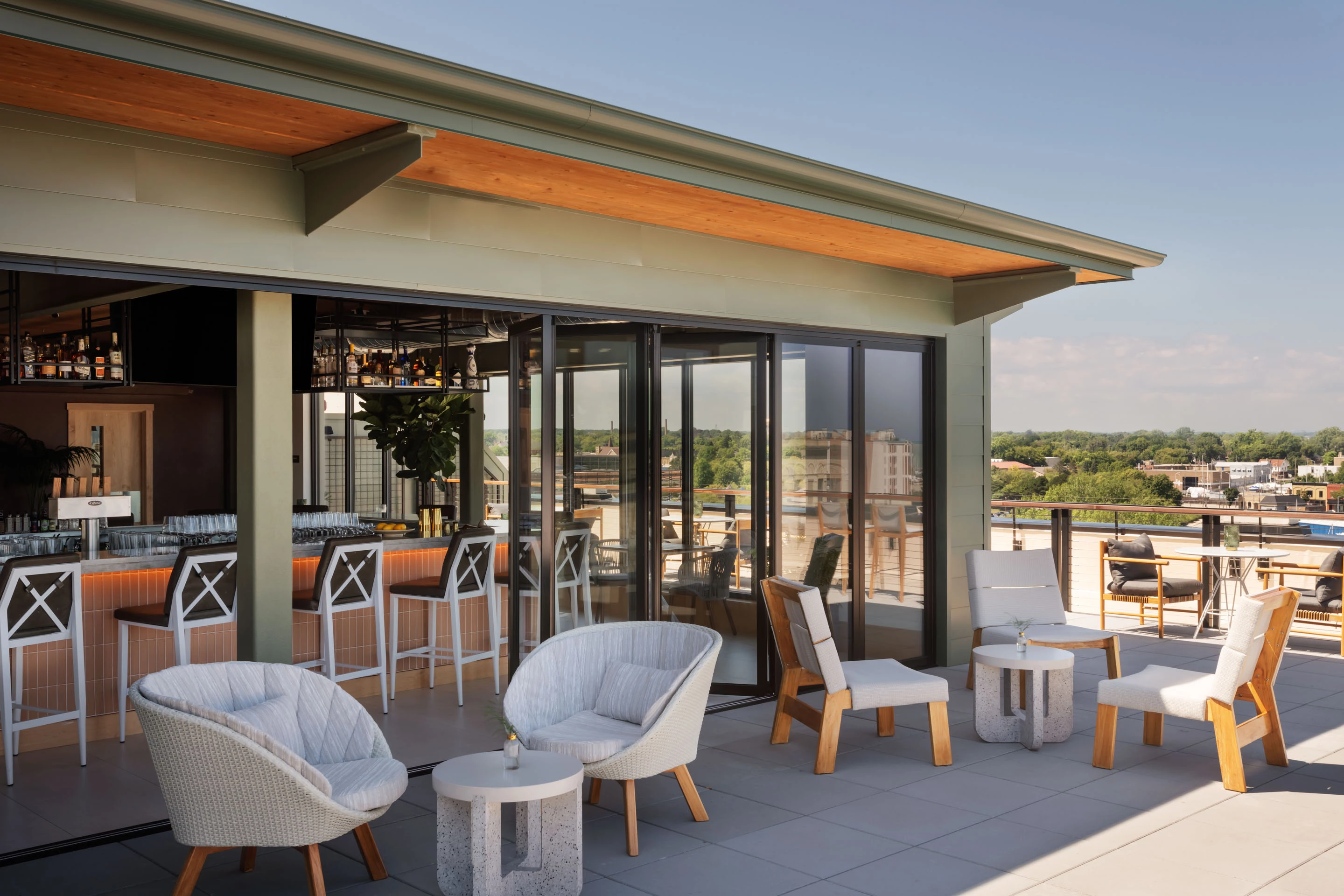 a patio with chairs and tables on a roof