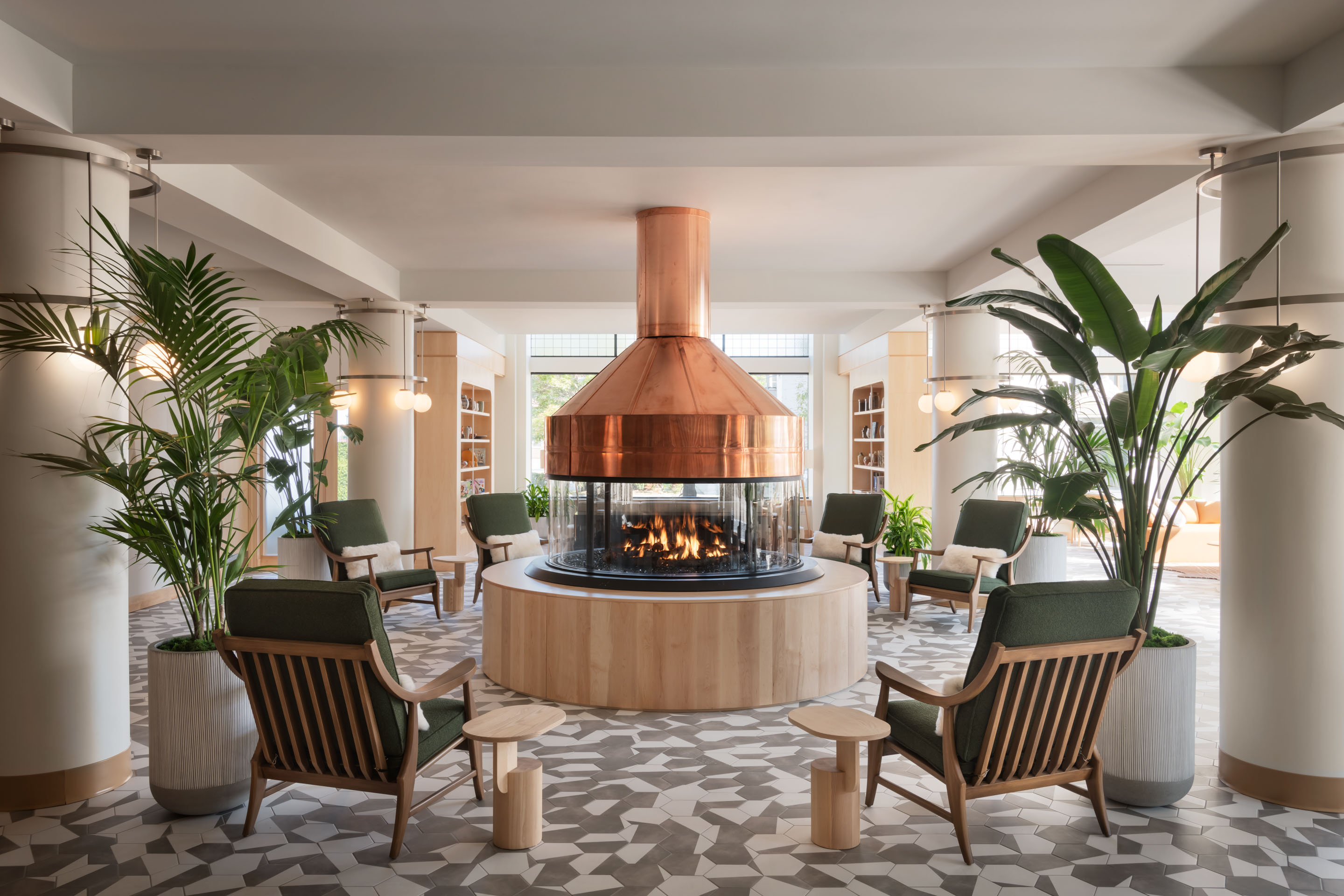 a room with a fireplace and chairs