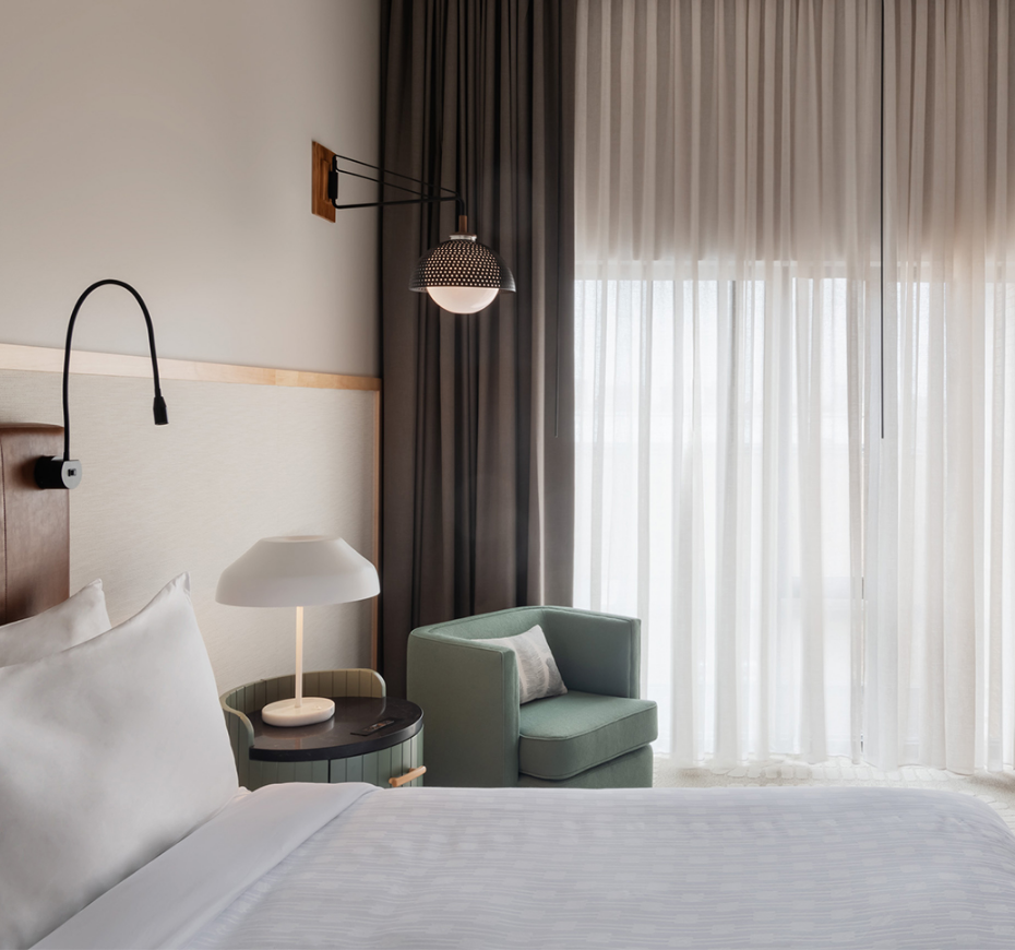 a bedroom with a bed and a chair