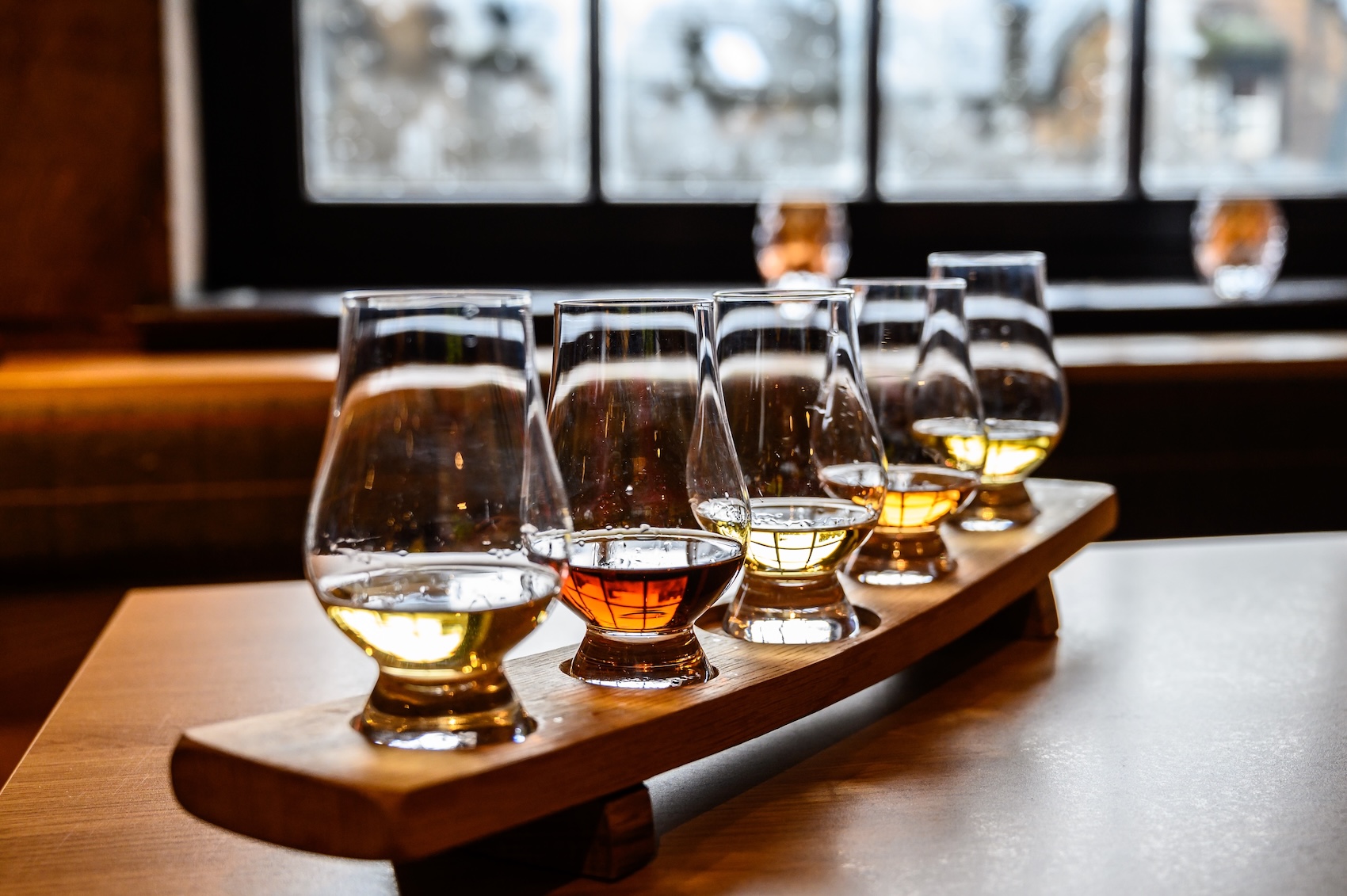 a row of glasses of different alcohol