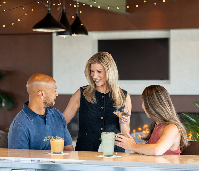a group of people sitting at a bar