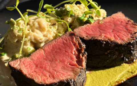 a plate of steak and mashed potatoes