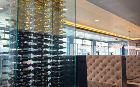 a glass wall with wine bottles on it