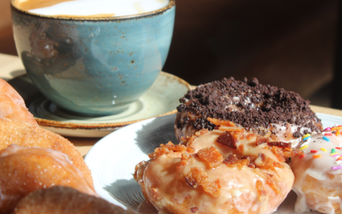 a plate of donuts and a cup of coffee