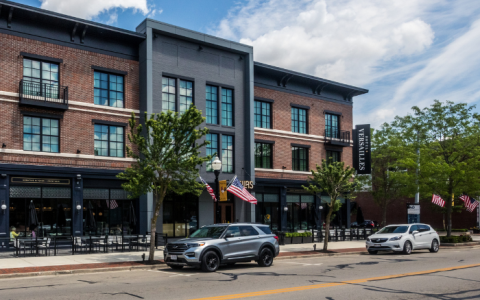 a building with cars parked on the side of the road