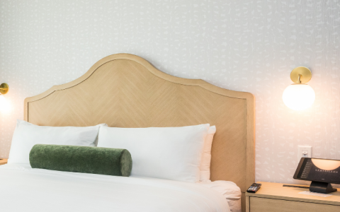 a bed with a telephone and a table