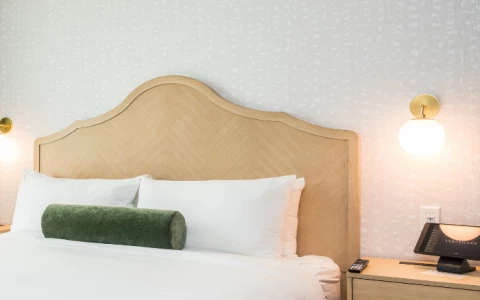 a bed with a telephone and a table