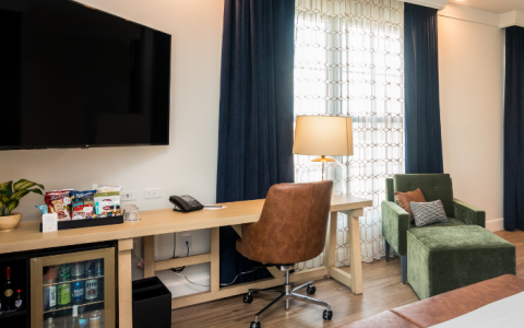 a room with a bed and a desk and chair