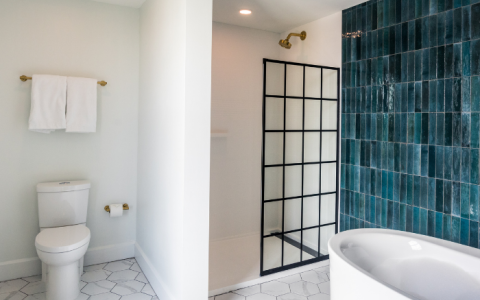 a bathroom with a tub toilet and shower