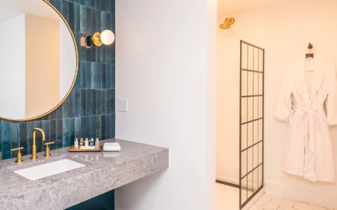 a bathroom with a white bathrobe and a mirror