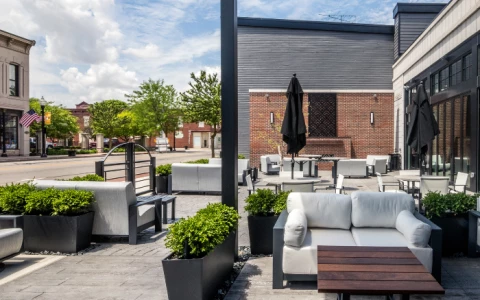 a patio with white furniture and plants