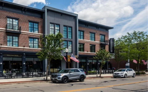 a building with cars parked on the side of the road