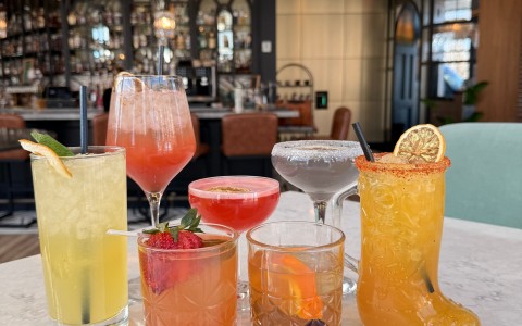 a group of different colored drinks on a table