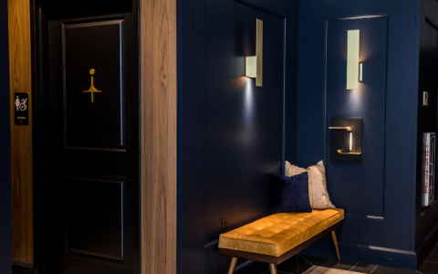 a hallway with a bench and a door