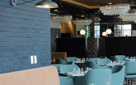 a restaurant with blue chairs and tables