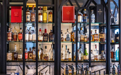 a shelf with bottles of alcohol