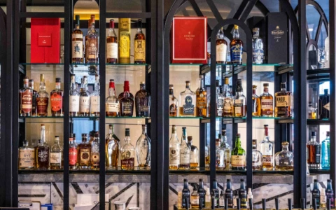 a shelf with bottles of alcohol