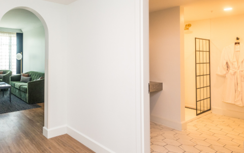 a room with a shower and a wood floor