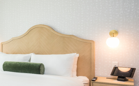 a bed with a telephone and a night stand