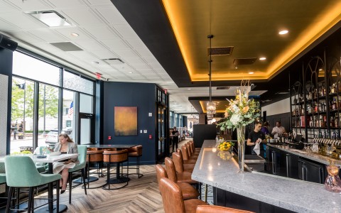 a restaurant with a marble counter and chairs