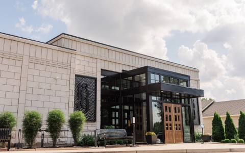 a building with glass doors and a bench