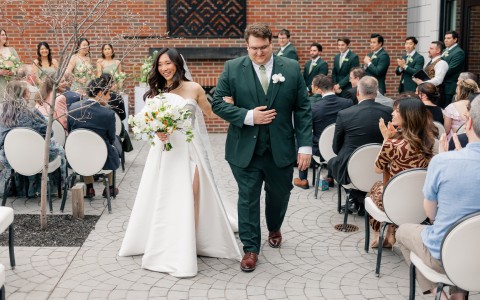 a man and woman walking down a patio