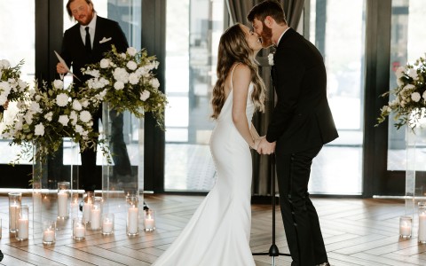 a man and woman kissing in a room