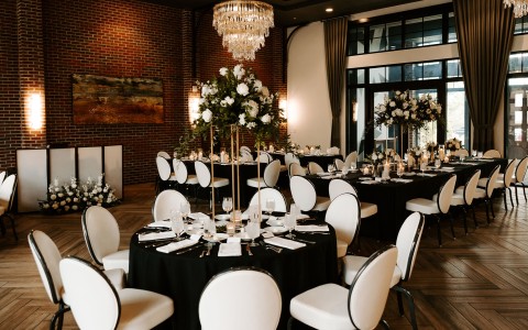 a room with black tables and white chairs