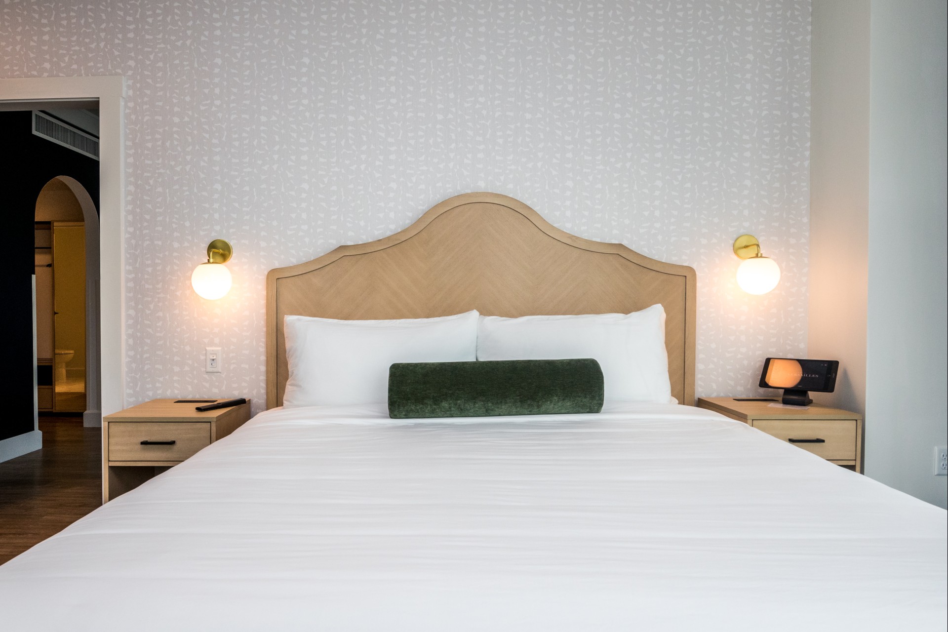 a bed with a green pillow on it