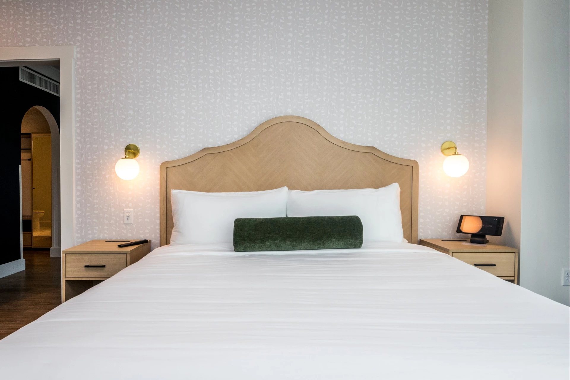 a bed with a green pillow on it