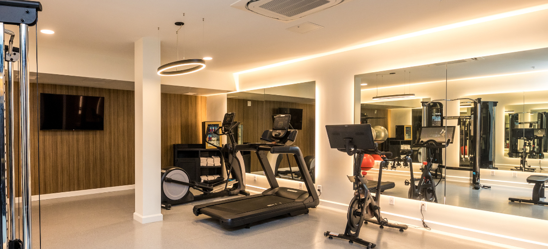 a room with exercise machines and a mirror