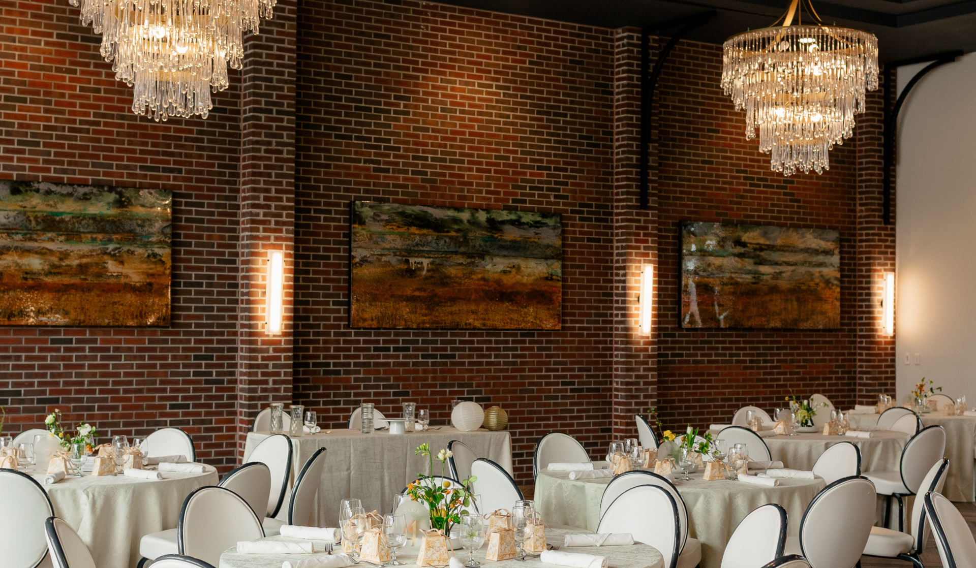 a room with tables and chairs and chandeliers