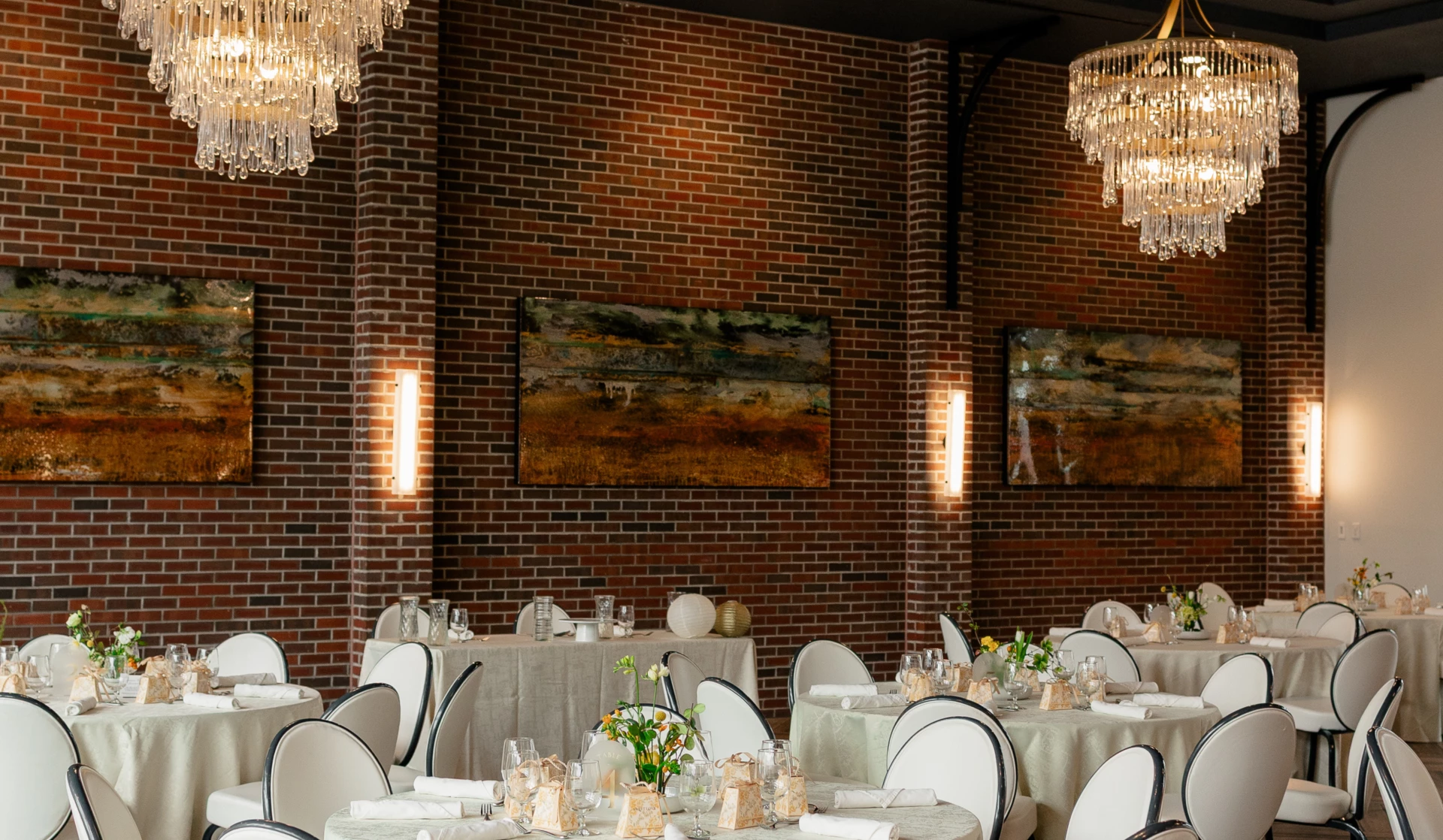 a room with tables and chairs and chandeliers