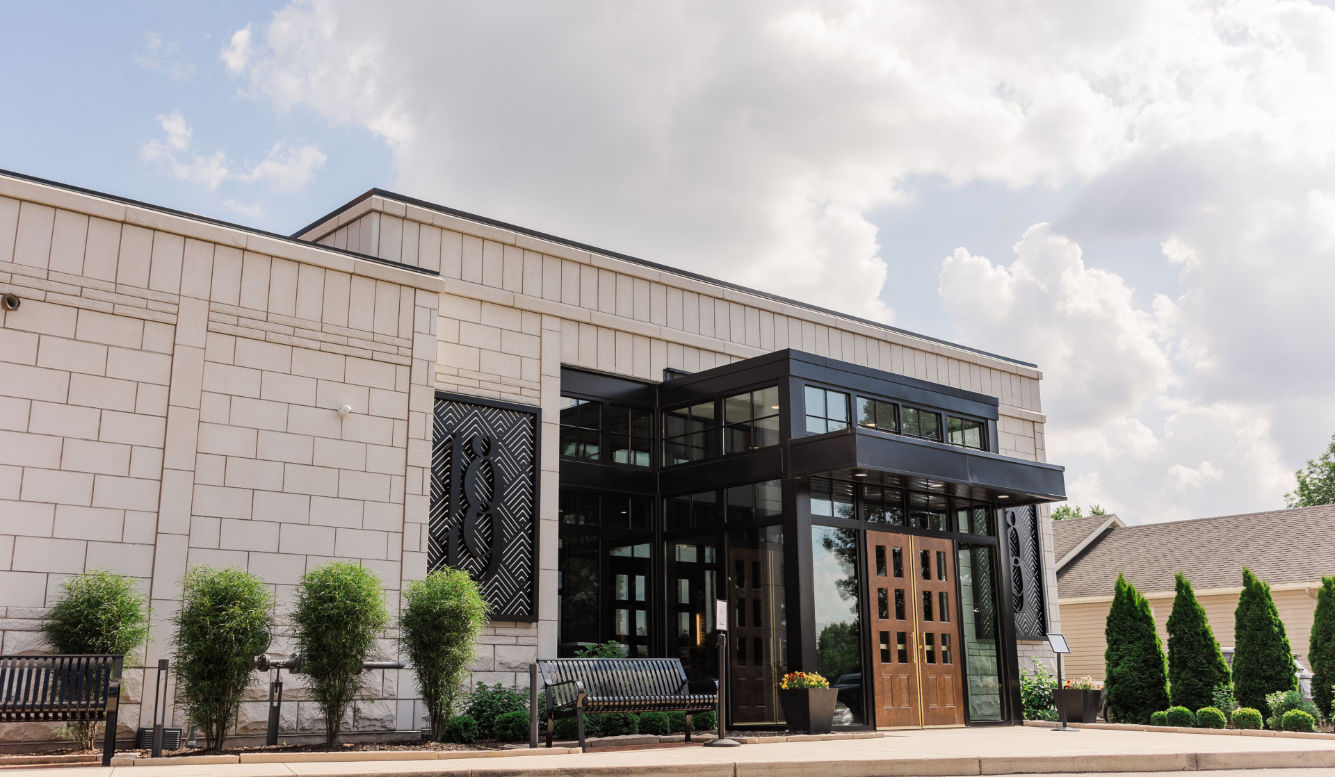 a building with glass doors and a bench