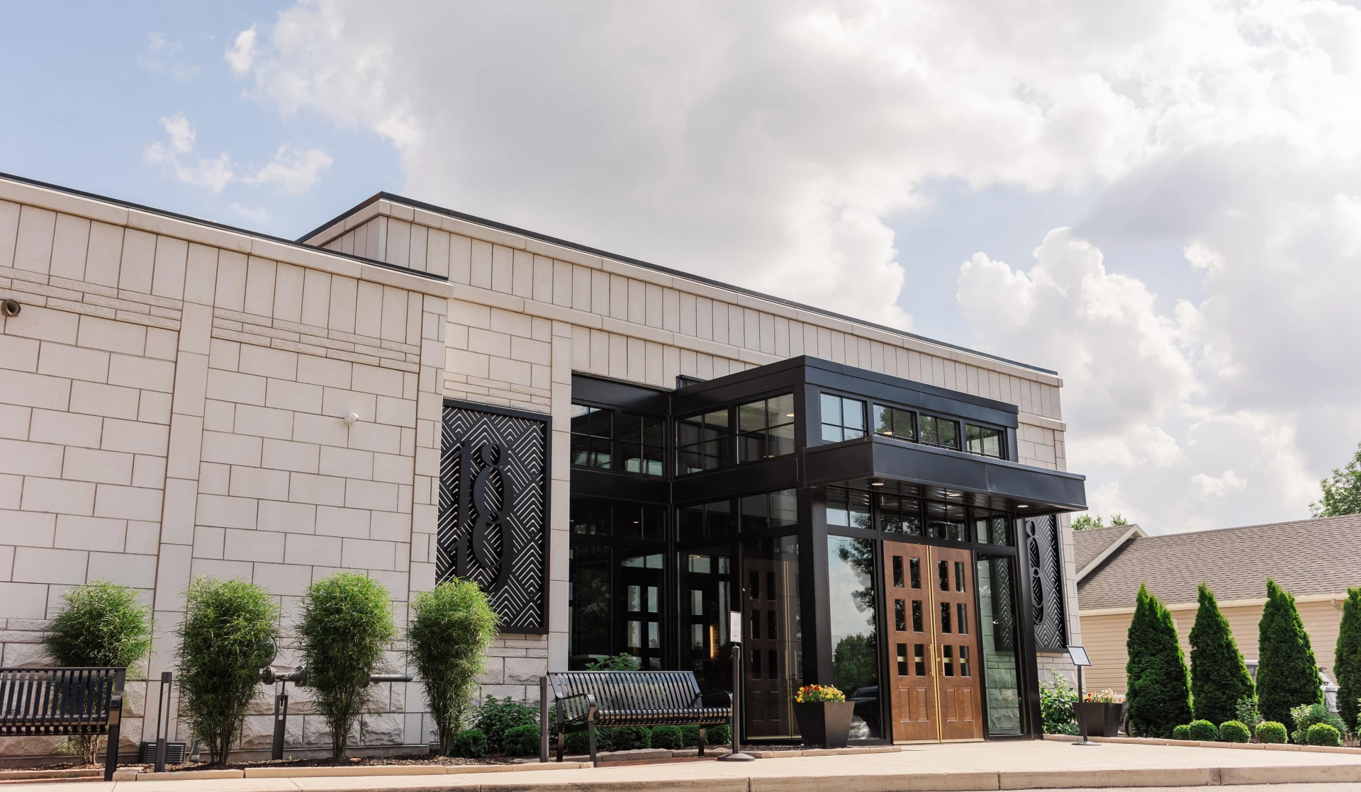 a building with glass doors and a bench