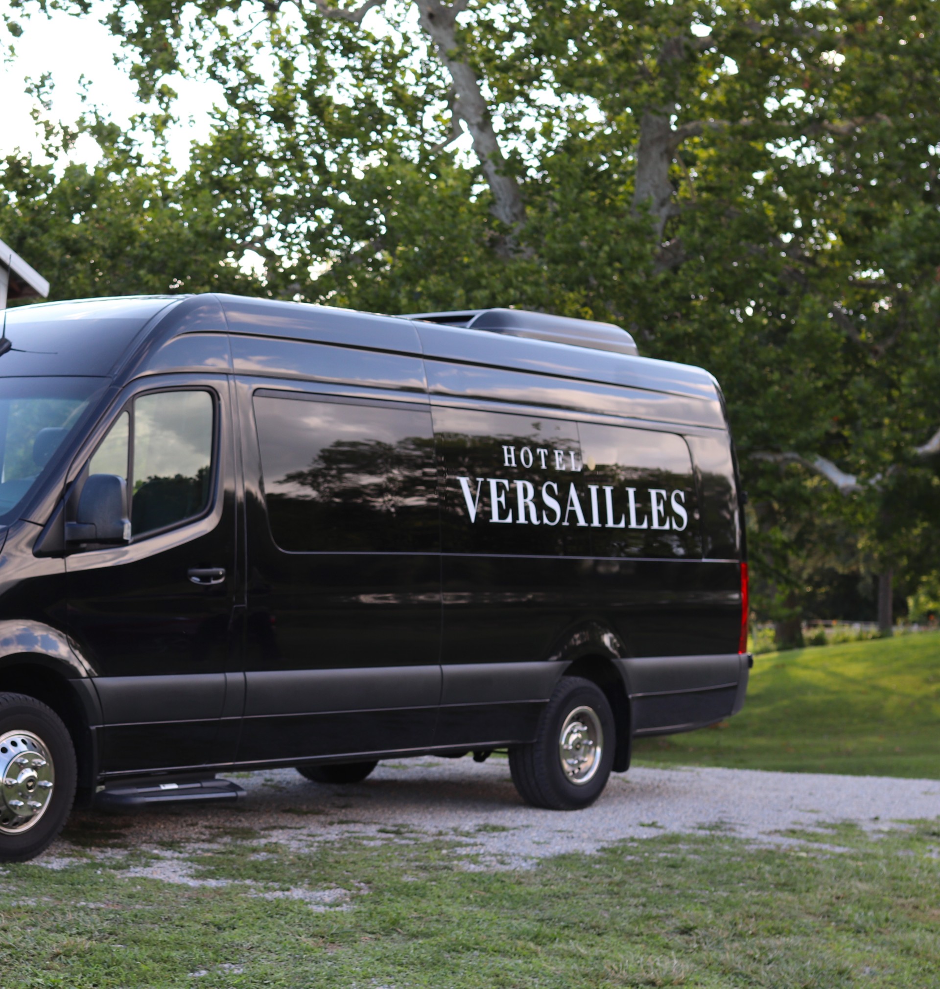 a black van parked on a gravel road