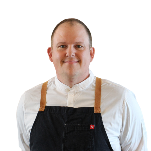 a man wearing a black apron